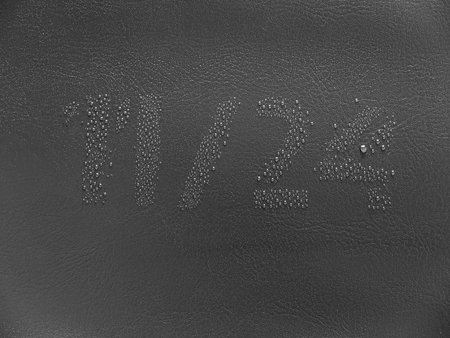 11 24 water drop stencil on the dark leather. Black friday 2017 date.