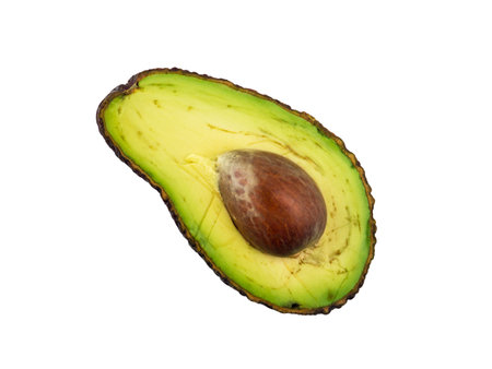 Ripe creamy avocado exotic fruit with seed and imperfections half cut top view flat lay isolated on...