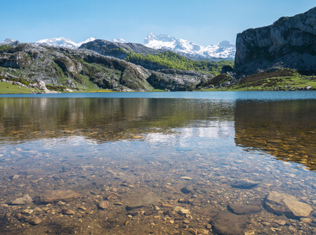 Alpine mountain lake landscape. Ercina lake in the Picos de Europa national park, Spain, Asturias. Snow on the mountain peaks.の写真素材