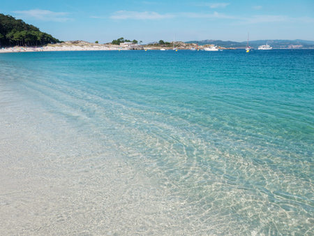 Crystal clear blue sea at the Cies islands. Turquoise shallow water and white Rodas sandy beach.
