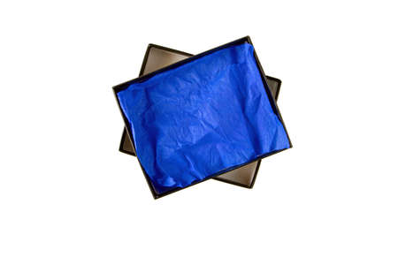 Opened black flat rectangular cardboard box with blue crumpled wrapping paper top view isolated on whiteの写真素材