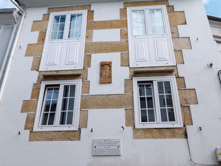 MONDONEDO, SPAIN - AUGUST 08, 2021:Marble plaque and portrait marking a home of writer,journalist and official town chronicler Eduardo Lence Santar, Mondonedo,Lugo,Galicia,Spainのeditorial素材