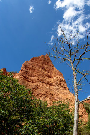 Rock peack and dry dead tree at the Las Medulas historic gold mining site near the town of...