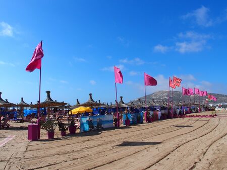 Red flags on beach in travel Agadir city in Moroccoのeditorial素材