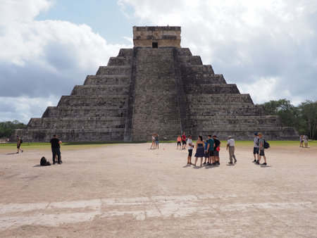 Pyramid and tourists in Chichen Itza mayan town in Mexico, ruins at archaeological site