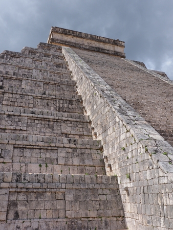 Stairs of Kukulkan pyramid at Chichen Itza mayan town, ruins at most impressive of archaeological sites in Mexico, cloudy blue sky in 2018 warm sunny winter day, North America on February - verticalの写真素材
