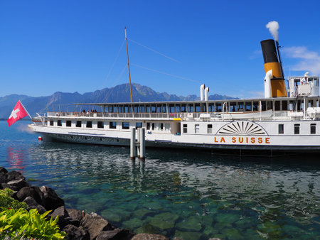 MONTREUX, SWITZERLAND on JULY 2017: Paddle-wheel steam boat moored ready to cruise at promenade on...