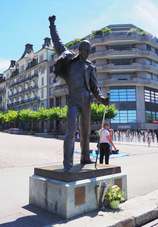 MONTREUX, SWITZERLAND on JULY 2017: Statue of Freddie Mercury, singer of rock band QUEEN at european city in canton Vaud, clear blue sky in warm sunny summer day - vertical.のeditorial素材