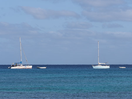 SANTA MARIA, CAPE VERDE on MARCH 2019: White yachts on clear turquoise waters of Atlantic Ocean landscapes at african Sal island, clear blue sky in warm sunny summer day.のeditorial素材
