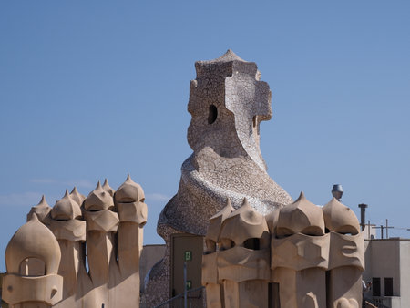 BARCELONA, SPAIN - SEPTEMBER 9th 2019: Artistic chimneys on rooftop in european city at Catalonia district, clear blue sky in warm sunny summer day.のeditorial素材