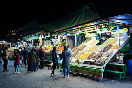 MARRAKESH, MOROCCO - 28 JANUARY 2023: Food souks on Jemaa el-Fnaa in African city, clear blue sky in...