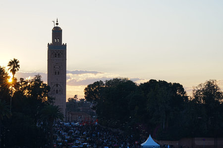 MARRAKESH, MOROCCO - 28 JANUARY 2023: Sun set with Kutubiyya mosque minaret and Jemaa el-Fna in...