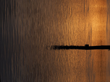 Stake and water reflection of sun set in Rhine River, European Stein am Rhein at Schaffhausen, Switzerland in 2018 summer evening on August - verticalの写真素材