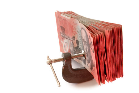 australian banknotes in a g-clamp, metaphor for restriction on spending