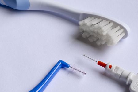 close up on two interdental brushes and one toothbrushesの写真素材
