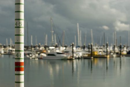 a graduated pole for measuring high tides in a marinaの写真素材