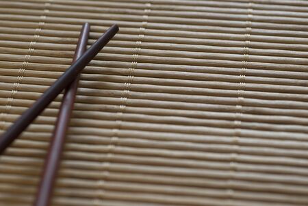 Chopsticks on a bamboo roll placematの写真素材