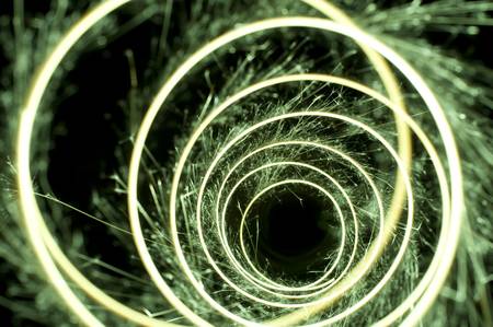 circular lines traced with a sparkler on a dark backgroundの写真素材