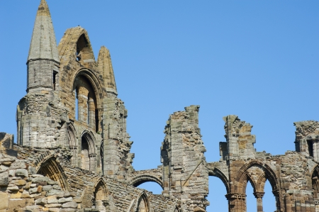 Close-up of the Whitby Abbey gothic ruins with the top of the facade and nave column during a sunny day. Whitby, North Yorkshire, England, United Kingdom, Europeの写真素材