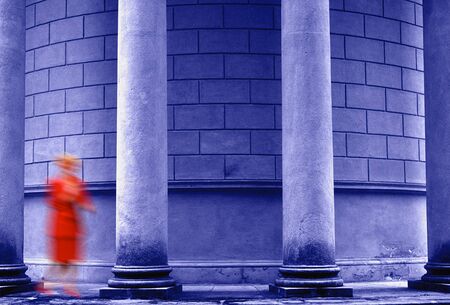 Young woman in red dress is walkingの写真素材