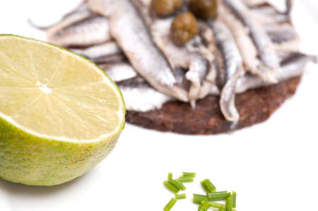 Lime and chives with a canape of sardines and capersの写真素材