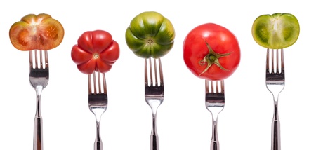 Display with five isolated different green and red tomatoesの写真素材