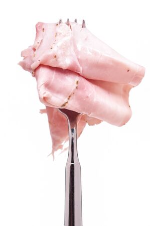 Fork with a slice of boiled ham with rosmaryの写真素材