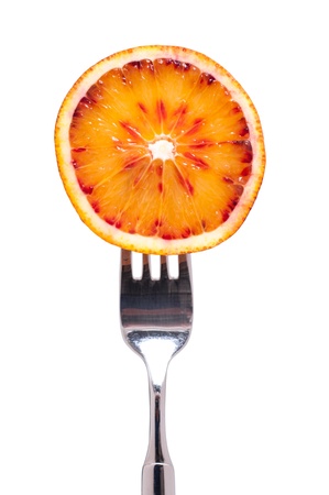 Fork with a sliced blood orangeの写真素材