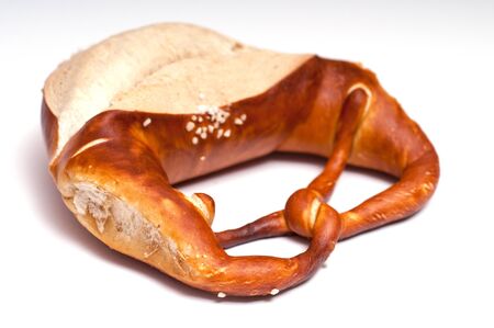 Brezel with salt on a white backgroundの写真素材