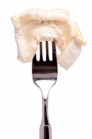 White isolated french soft cheese on a forkの写真素材
