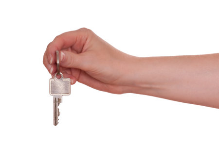 White isolated female hand is holding a key