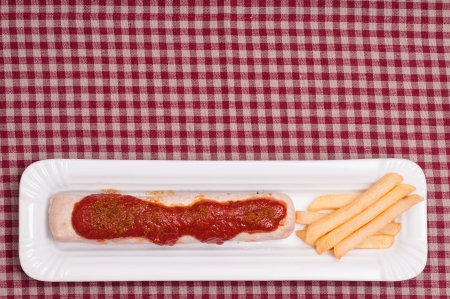 Currywurst with sauce, chips and text spaceの写真素材