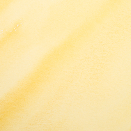 Monochrome watercolor background on paper in yellowの写真素材