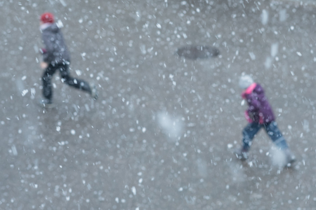Snow flakes and unsharp children in winterの写真素材