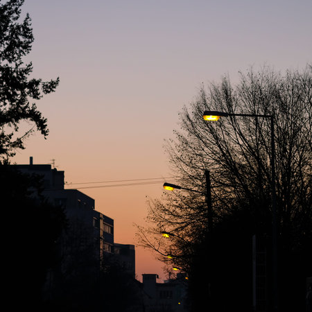 Yellow street lanterns with office buildings in the duskの写真素材