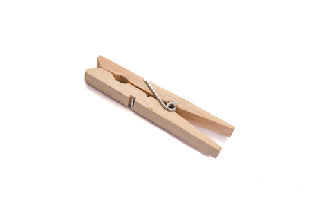 Wooden clothes peg with metal spring white isolatedの写真素材