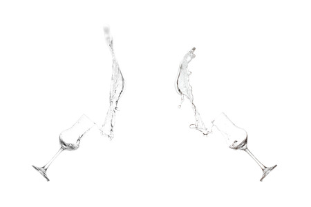 Isolated splashes with grappa sloshing out of a shot glassの写真素材