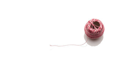 Pink and white ball of wool in panorama format white isolatedの写真素材