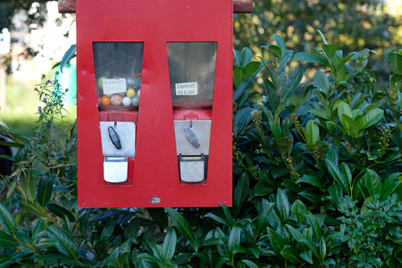 Red Chewing gum machine with sweets and sold outの写真素材