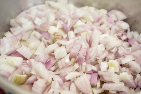 Little chopped onions sweating in a cooking potの写真素材