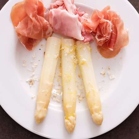 White asparagus with raw ham and cheese belper knolleの写真素材