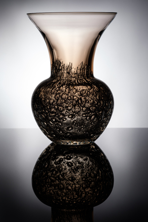 Glass vase with bubbles in back lit with relfectionの写真素材