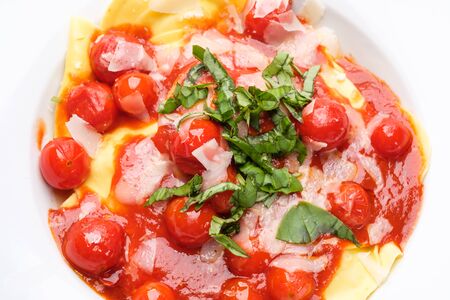Top view tomatoes tomato sauce basil parmesan and tortelliniの写真素材