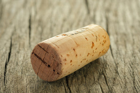 Wine cork on wooden rustic board in back lit