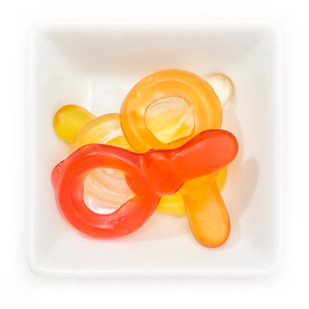 Gum dummy pacifier in a white bowl in top view