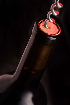 Wine bootle wiht cork screw opener in vertical format focus stackingの写真素材