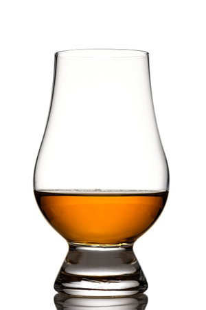Glencairn glass with singe malt whiskey in back lit