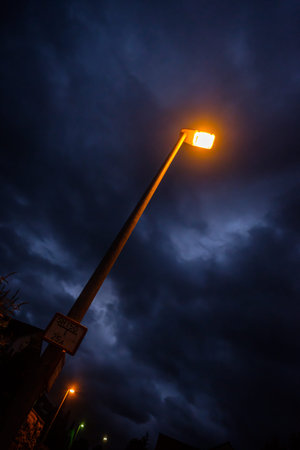 ellow light of a street lamp with clouds in the sky wide-angleの写真素材