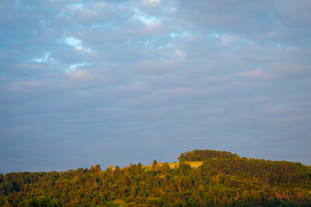 Peak of the hill SchÃ¶nbÃ¼hl in Germany with cloudy skyの写真素材