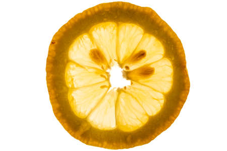Yellow slice of lemon close-up in back litの写真素材
